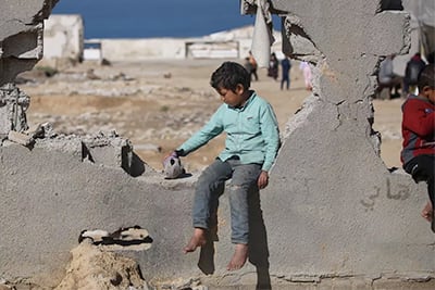 child in Gaza playing with a toy
